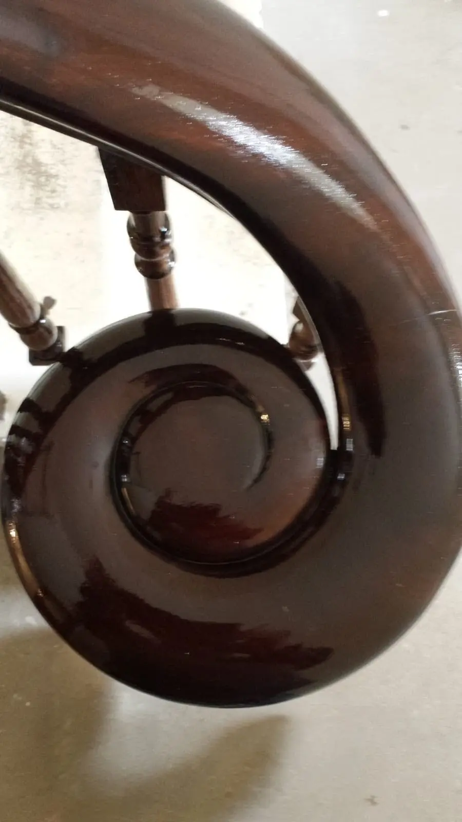 Restored dark wood bannister & volute with a high gloss finish.