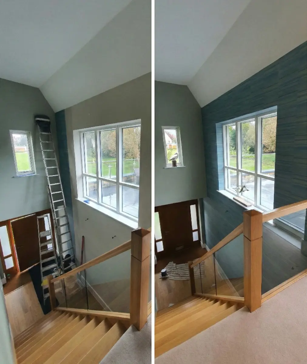 High-ceiling stairwell renovation long drop installation of textured blue horizontal-striped wallpaper.