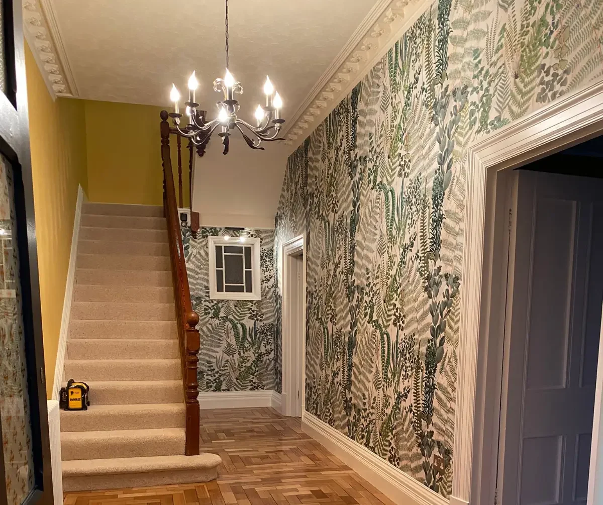 Entrance hall with large scale botanical wallpaper.