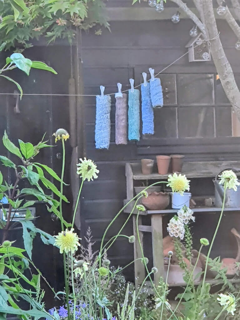 Washed paint rollers drying outside the garden studio